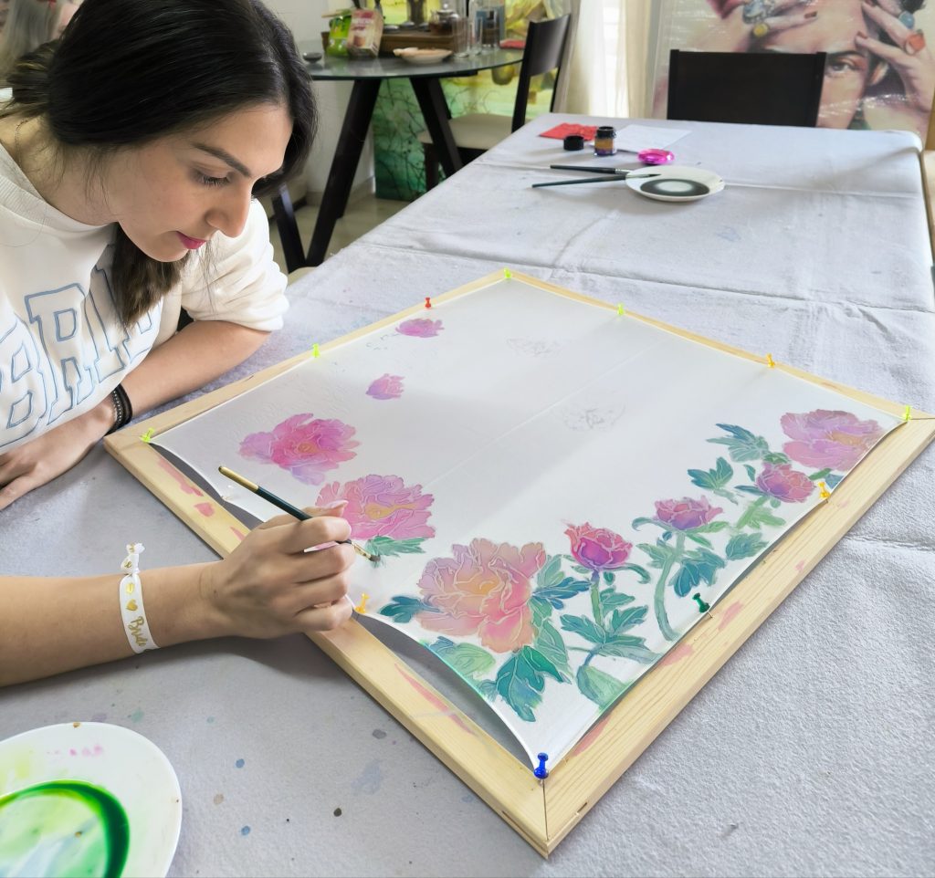 Traveler creating a handmade silk scarf in Athens