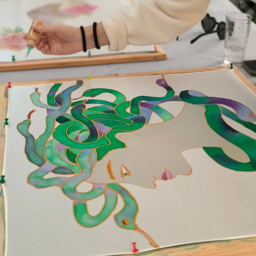 Traveler creating a handmade silk scarf in Athens
